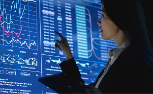 Analyst exploring live business intelligence charts on a large screen