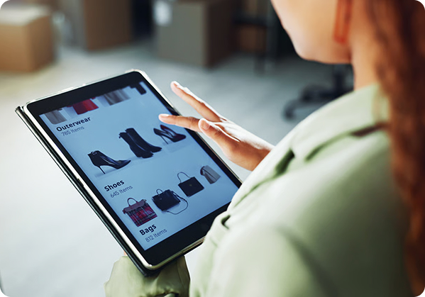 Shopper browsing product categories on a tablet in a fulfilment space