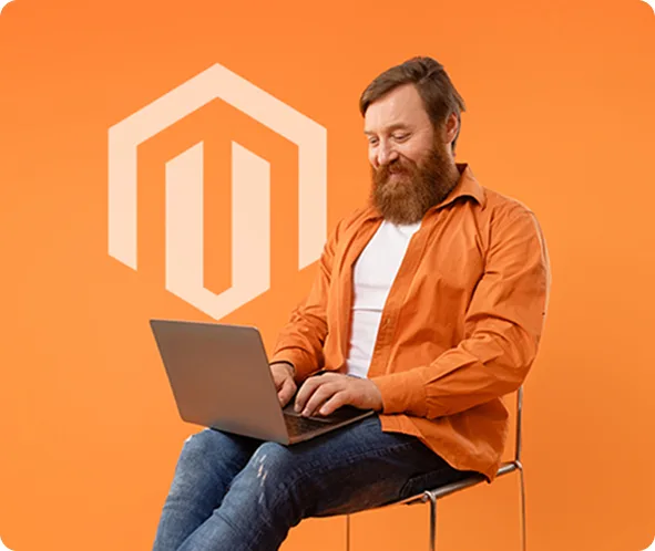 Magento developer working on a laptop beside the Magento logo