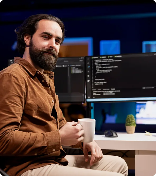 chillicommerce Magento migration developer at a multi-screen workstation