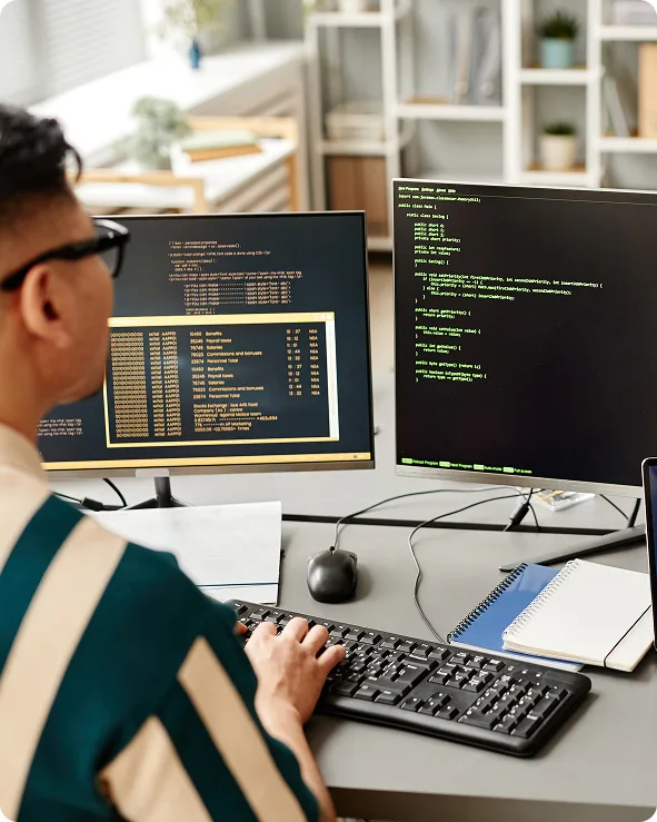 chillicommerce Magento to Shopify migration team working at a multi-screen desk